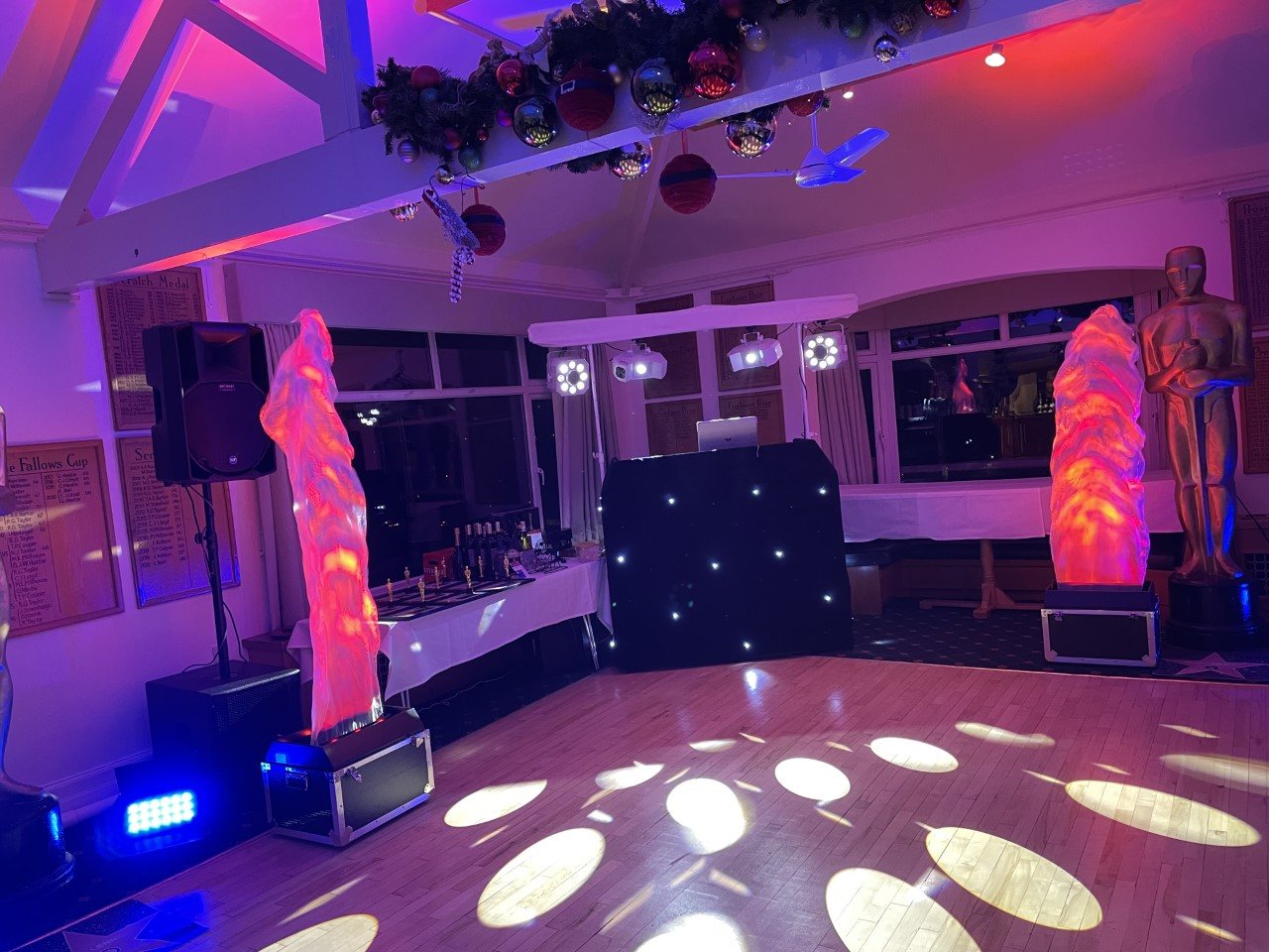 Themed awards-night disco setup with flame lighting columns and a starlit booth