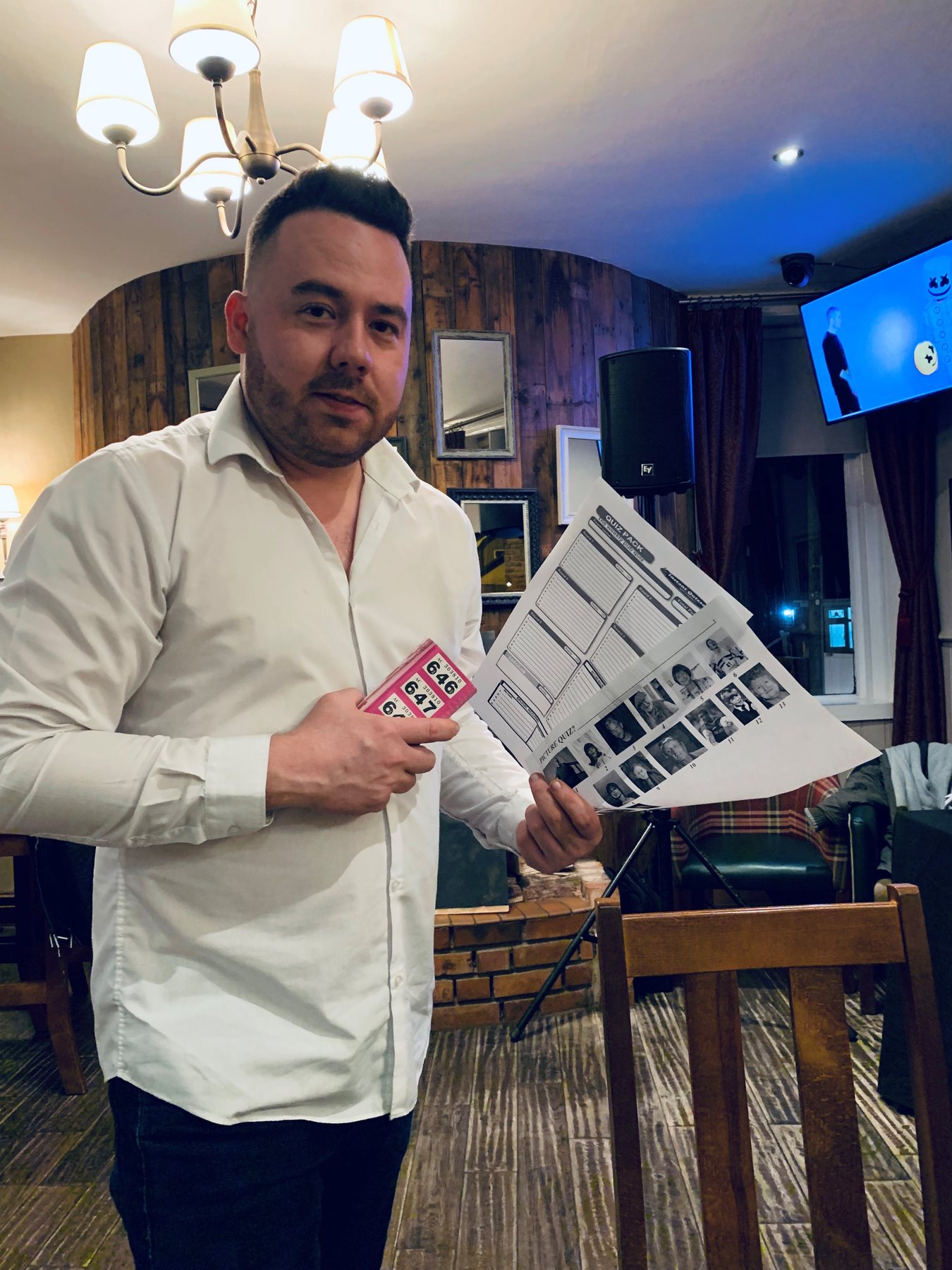 Andy hosting a picture round quiz night in a pub function room